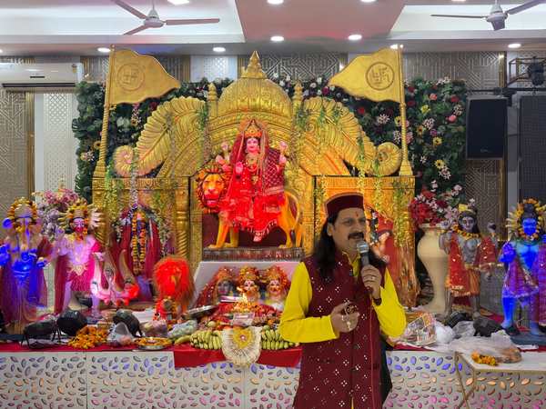 Prem Bhatnagar ji singing in front of Mata's darbar, with Durga Mata on her lion behind him
