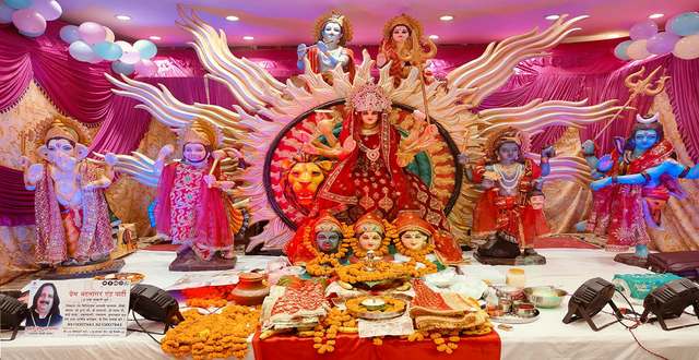 Mata's darbar for a Mata Ki Chowki / Jagran: Durga Mata on her lion with Ganesh ji, Hanuman ji, Shiv ji and Mata's forms, marigolds and the jyot in front